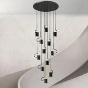 Black decorbites led staircase chandelier with sleek curved metal arms and cylindrical lights for modern villa decor