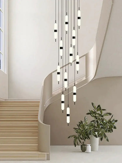 Modern minimalist decorbites led staircase chandelier with frosted glass tubes and black accents above staircase ceiling