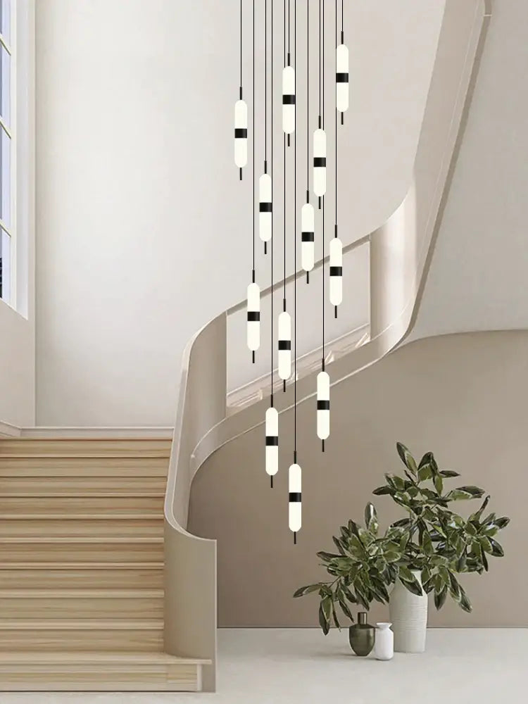 Modern minimalist decorbites led staircase chandelier with frosted glass tubes and black accents above staircase ceiling