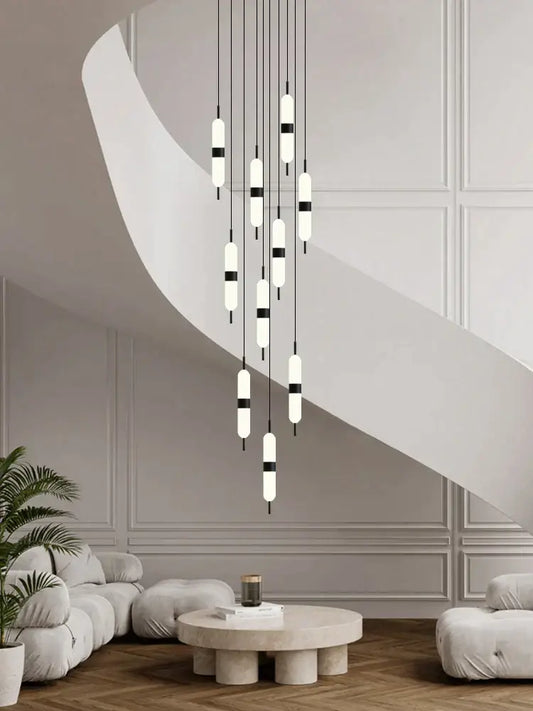 Modern minimalist decorbites led staircase chandelier with white and black cylindrical bulbs suspended by thin cords