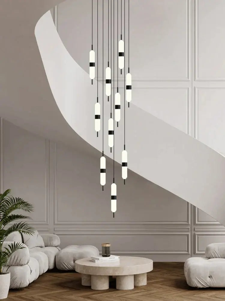 Modern minimalist decorbites led staircase chandelier with white and black cylindrical bulbs suspended by thin cords