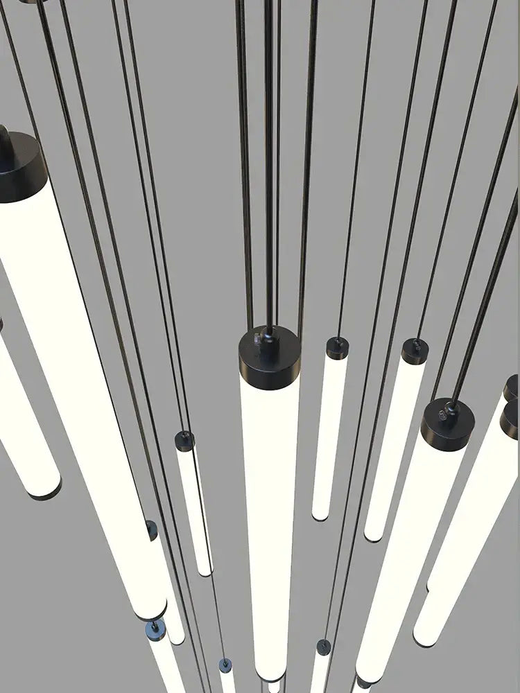 Modern minimalist staircase chandelier by DecorBites featuring sleek black cylindrical led fixtures with glowing white tubes