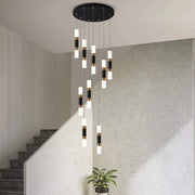 Modern black and gold cylindrical led staircase chandelier hanging from a circular ceiling fixture for duplex homes