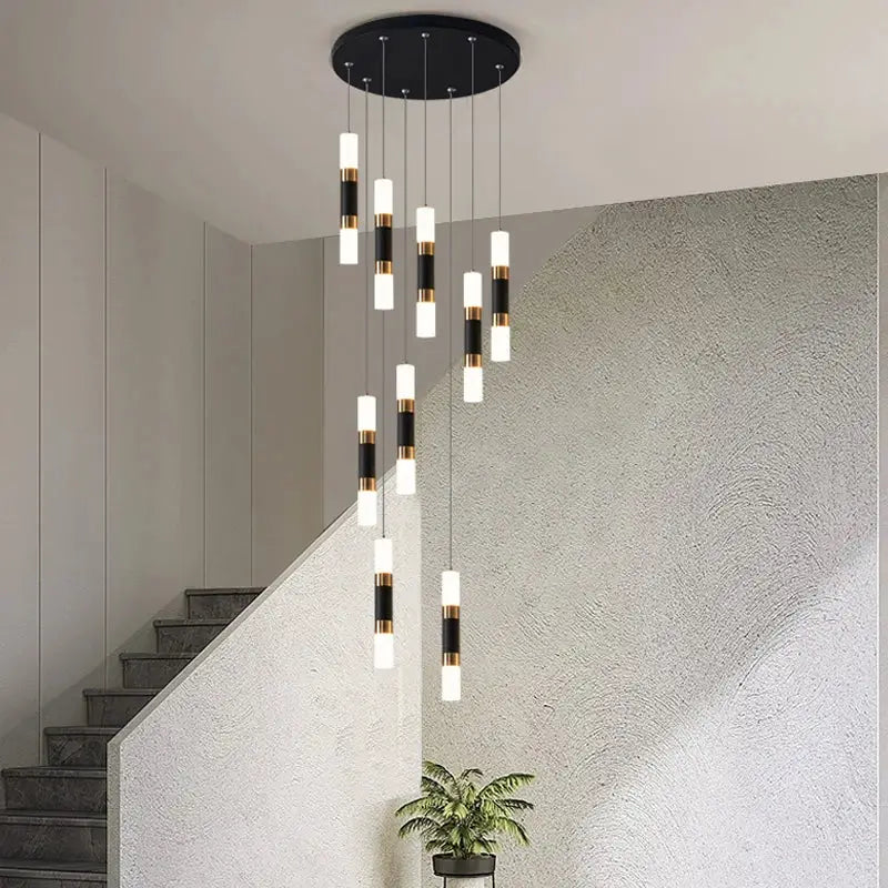 Modern black and gold cylindrical led staircase chandelier hanging from a circular ceiling fixture for duplex homes