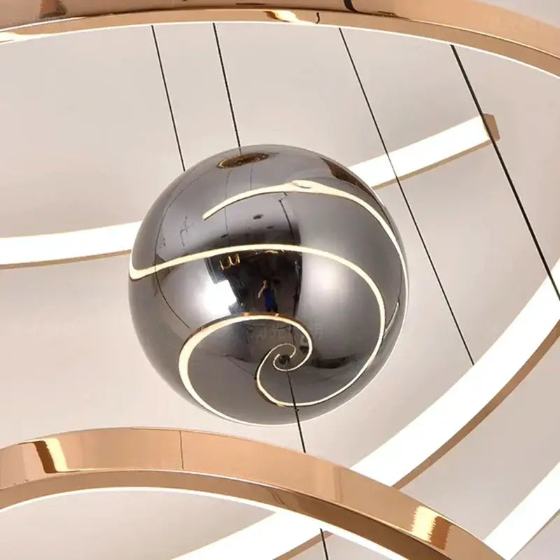 A sleek chrome pendant light with gold spiral accents from decorbites led staircase chandelier collection for indoor use