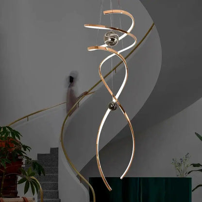 A modern decorbites led staircase pendant light with brushed gold finish and integrated led lighting for indoor use