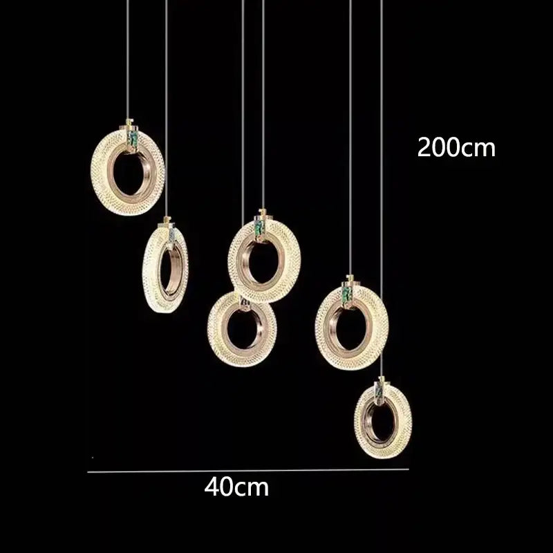 Gold-toned circular decorbites led staircase chandeliers with textured diamond surface and green accents for modern living rooms