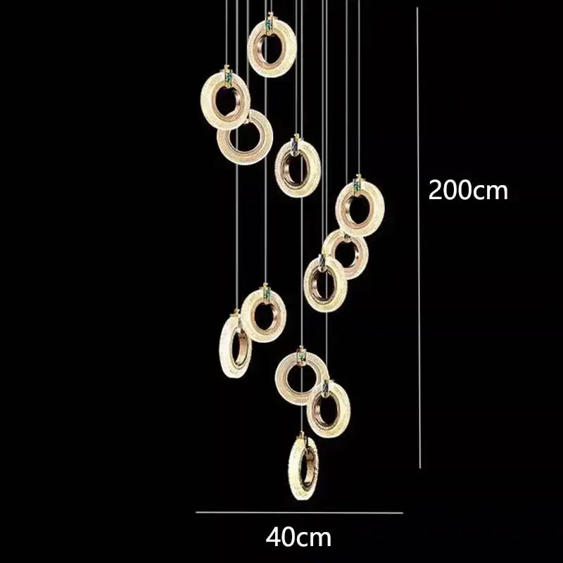 A modern 200cm tall decorbites led staircase pendant chandelier with gold rings and embedded green gemstones