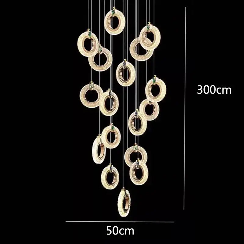 Gold-toned decorbites led staircase chandelier with embedded led lights and crystal accents in cascading design for modern living rooms
