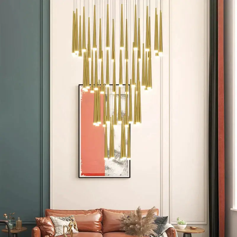 Golden cylindrical decorbites led staircase chandelier with multiple slender rods in cascading arrangement for modern luxury