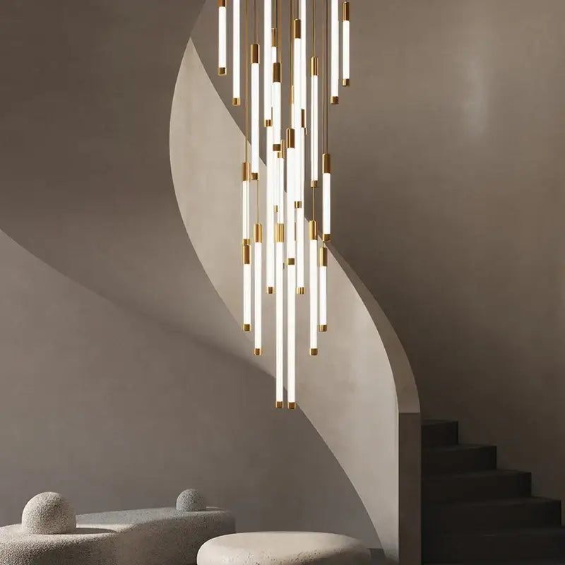 Modern minimalist decorbites™ led staircase chandelier with white cylindrical tubes and gold accents for luxury lighting