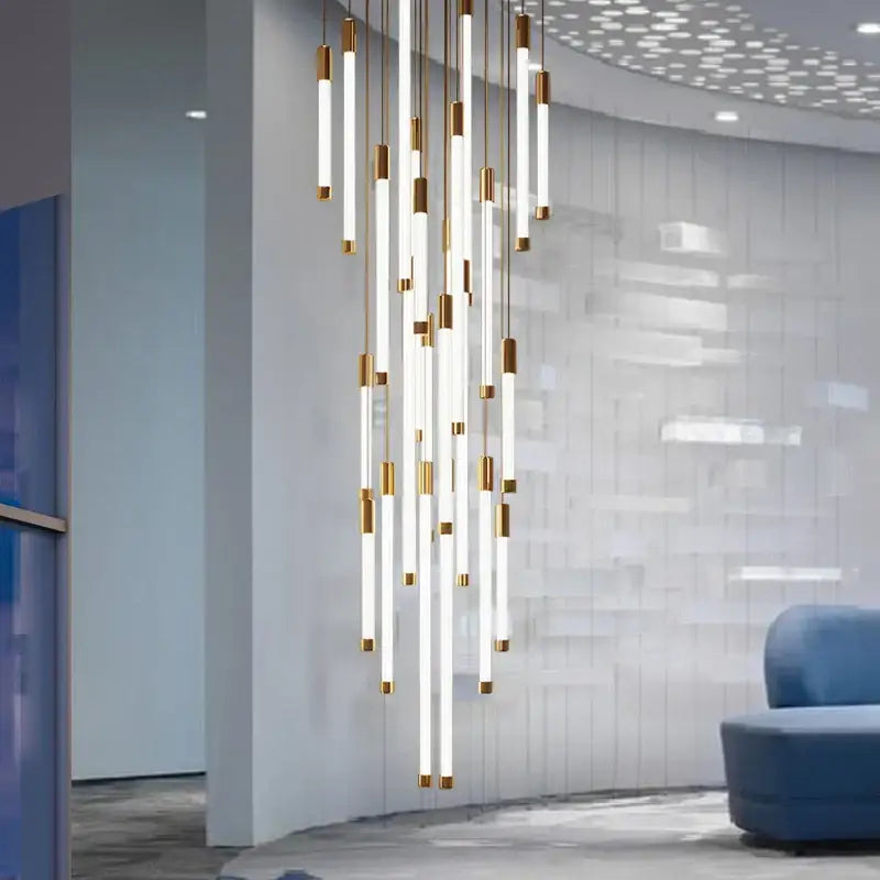 Modern LED staircase chandeliers by DecorBites with frosted glass tubes and gold metal accents for upscale interiors
