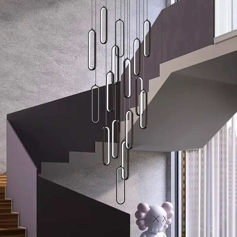 Modern black and silver oval decorbites led staircase pendant lights hanging above a staircase for living room use