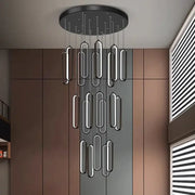 Modern black circular DecorBites LED staircase chandelier with sleek elongated oval pendant lights for living room decor