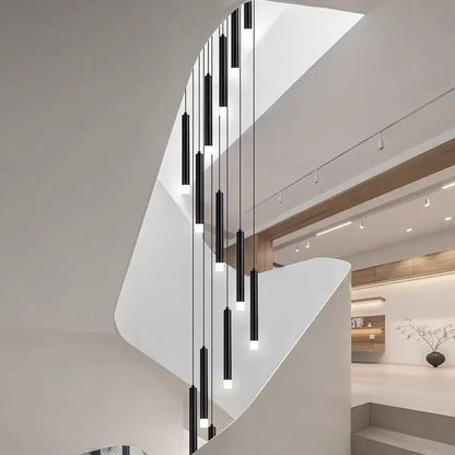 A modern black cylindrical decorbites led staircase pendant light fixture with sleek minimalist design for living room decor