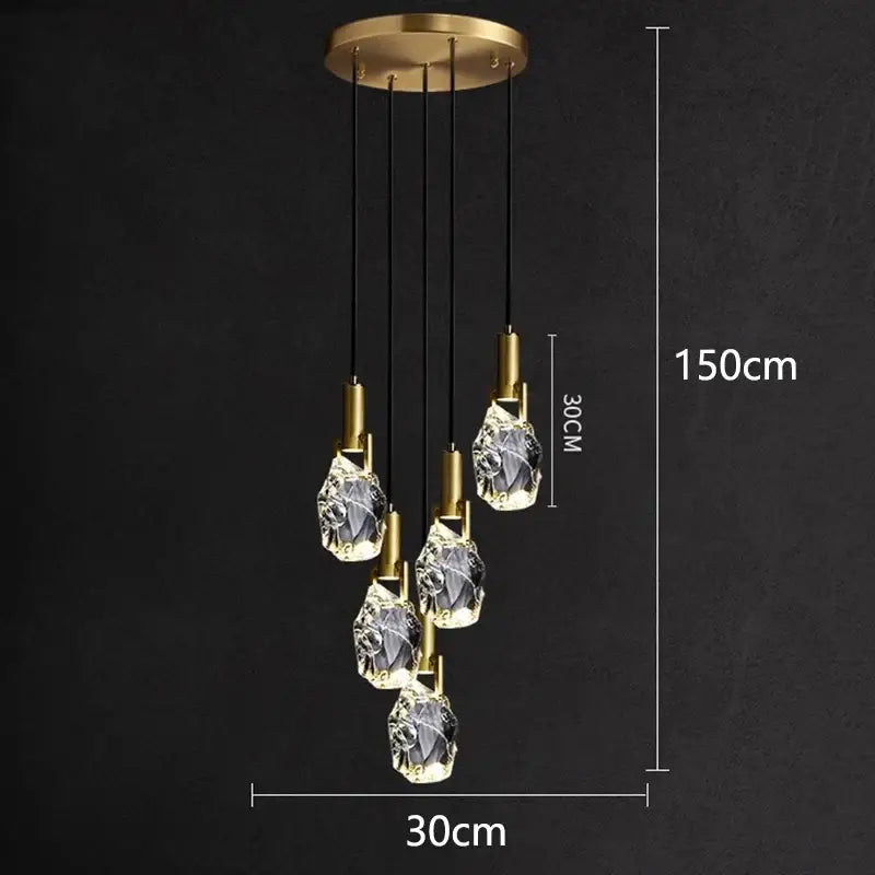 A modern decorbites led staircase pendant light with five faceted glass pendants and gold-toned ceiling mount