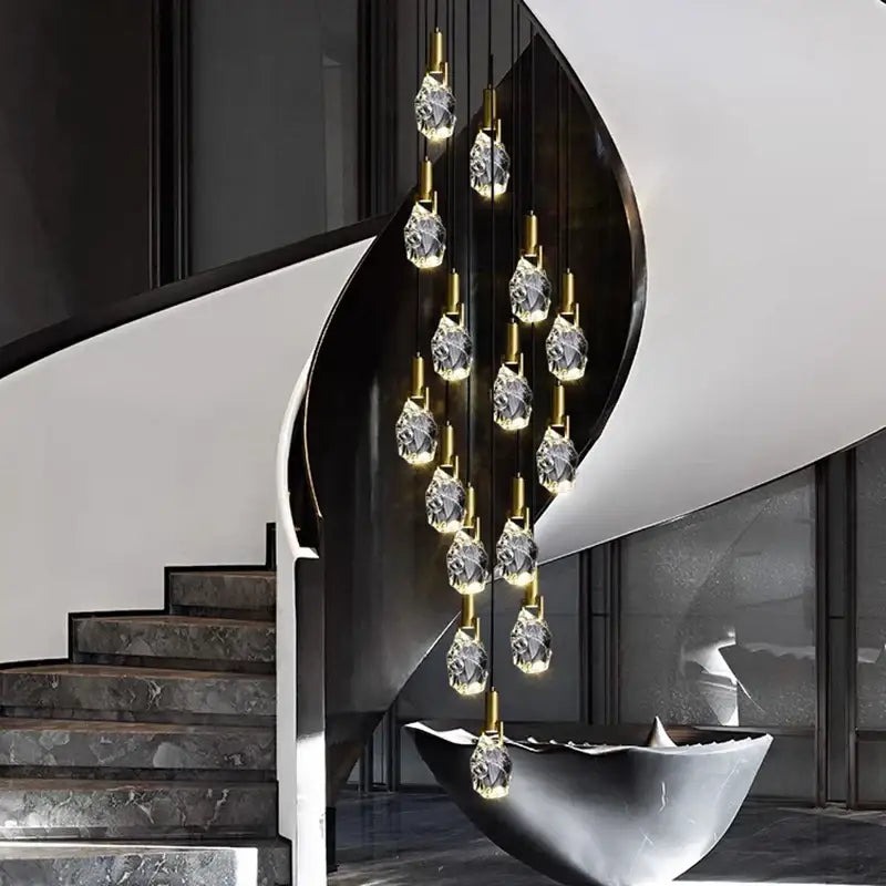 A modern decorbites led staircase pendant light with faceted crystal pendants and gold-toned rods for indoor use