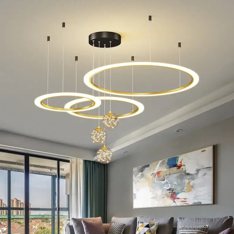 Modern gold-toned circular decorbites led star chandelier with glowing led rings and crystal accents for living room decor
