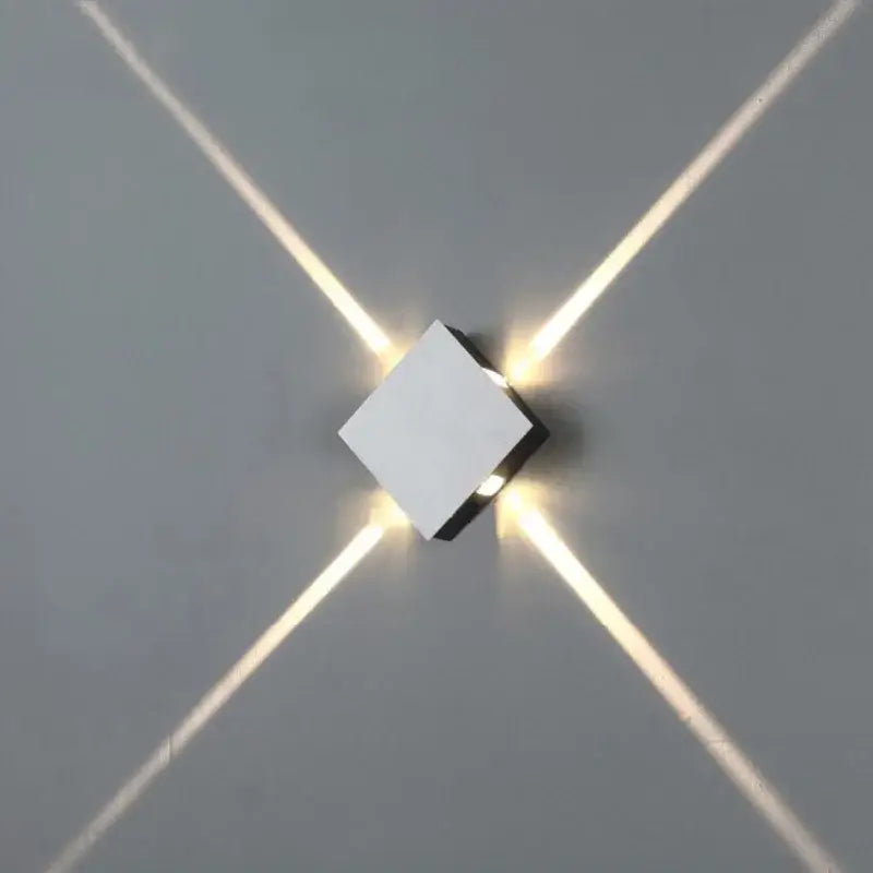 Modern white cube wall light decorbites led star with four angled leds casting warm glow for bar and hotel decor