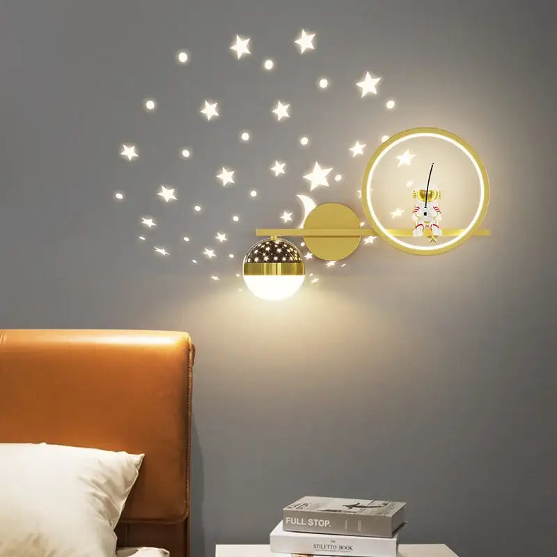 Gold-toned decorbites led star wall light with illuminated crescent moon globe in modern children’s bedroom decor