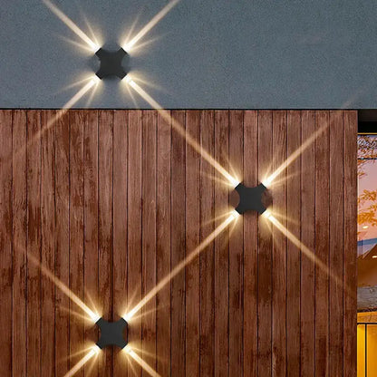 Black hexagonal DecorBites LED Starlight wall lamp with starburst light patterns for garden and indoor use