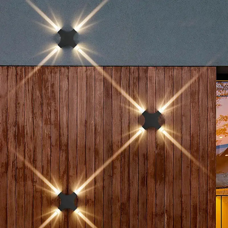 Black hexagonal DecorBites LED Starlight wall lamp with starburst light patterns for garden and indoor use