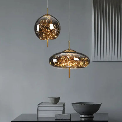 Two modern glass pendant lights with golden filaments suspended by brass rods from decorbites led starry sky lamps
