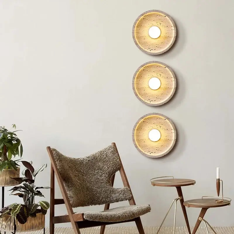 Three circular wall lamps with textured earthy-toned concrete finish and warm glow decorbites led stone wall lamp