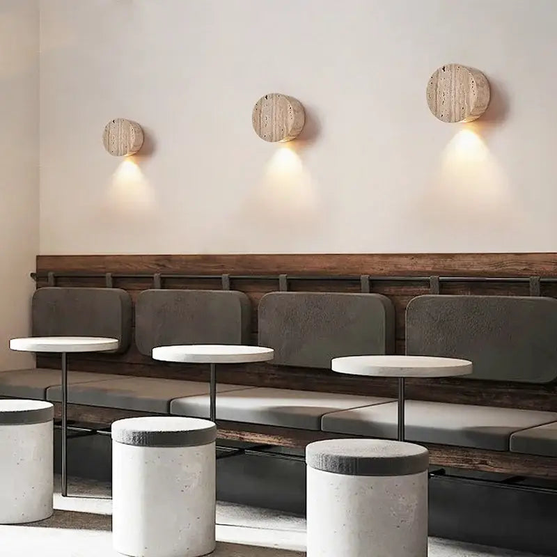 Three circular wooden wall lamp sconces with a natural rustic finish by DecorBites LED stone wall for modern interior use