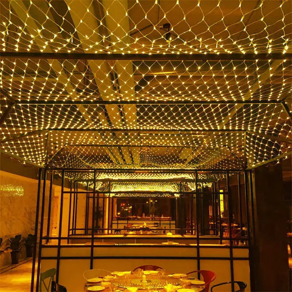 Warm white decorbites led string lights woven in a netted grid overhead create ambient glow for party decor