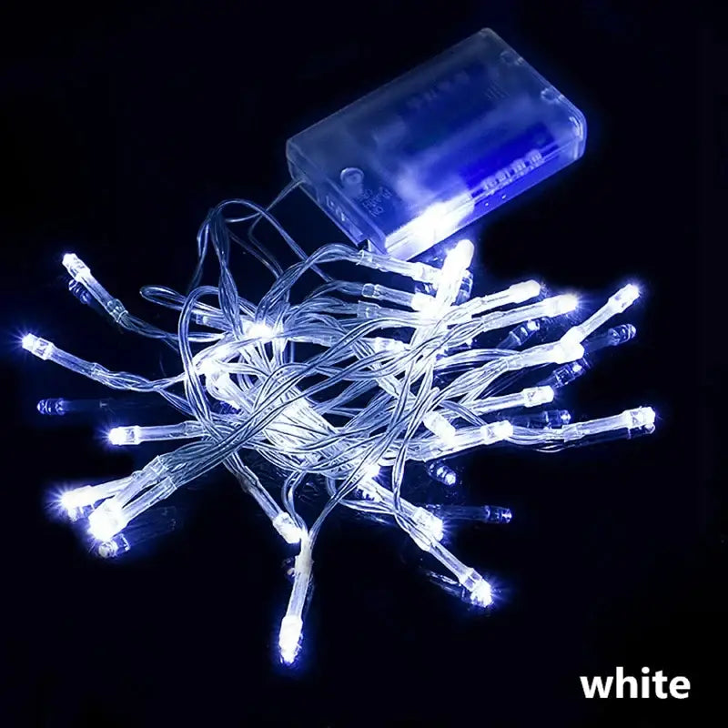 White decorbites led string featuring clear plastic bulbs and a transparent battery pack for holiday parties and weddings