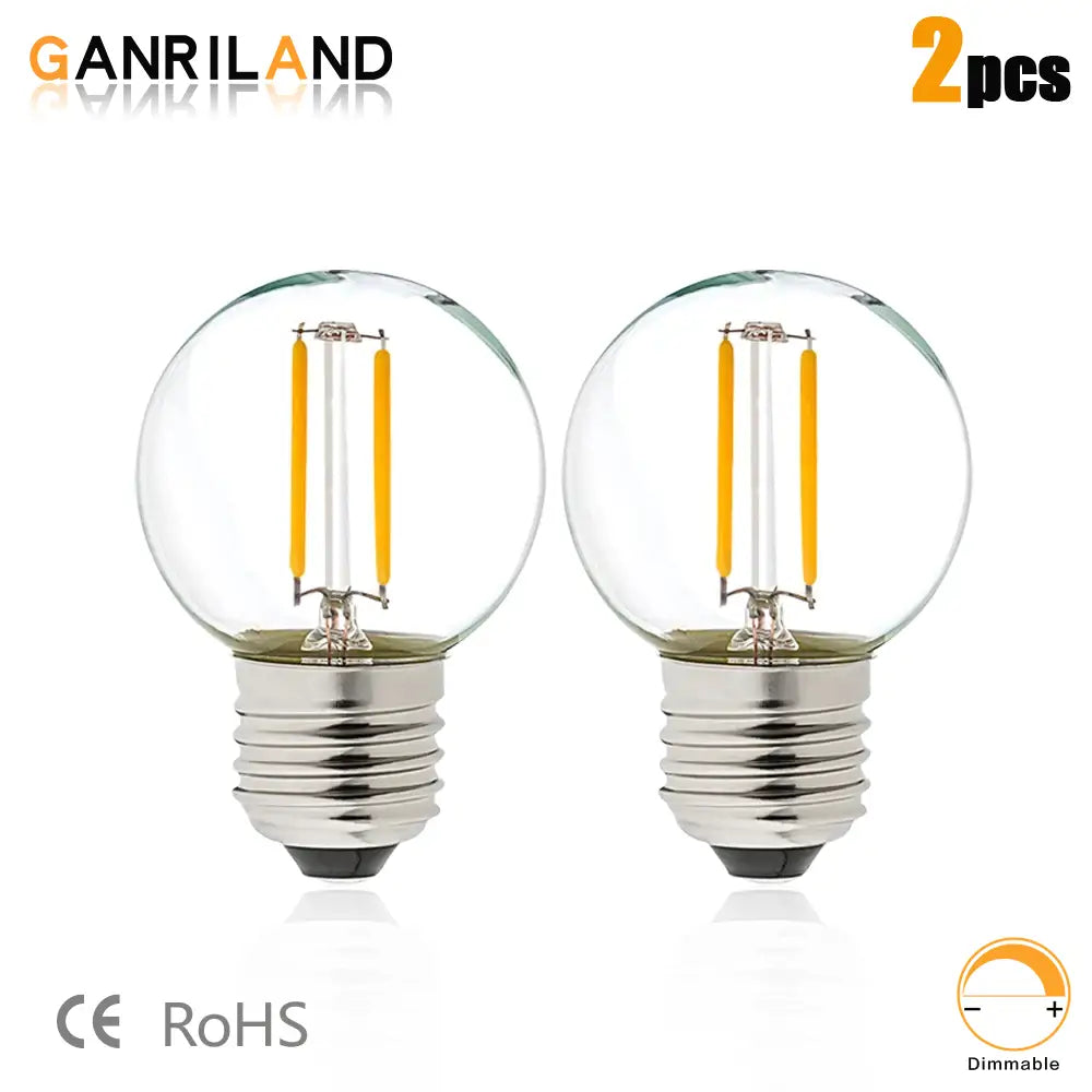 Two clear glass globe led bulbs with warm yellow filament and silver bases for decorbites led string lights