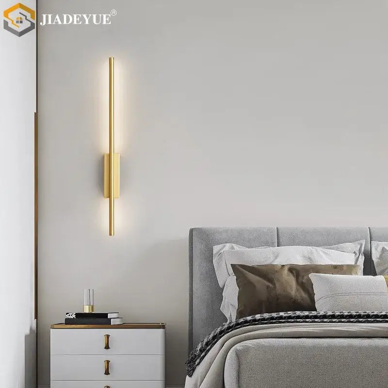 Gold-toned minimalist decorbites led strip copper wall lamp with sleek vertical design and warm ambient lighting for living room