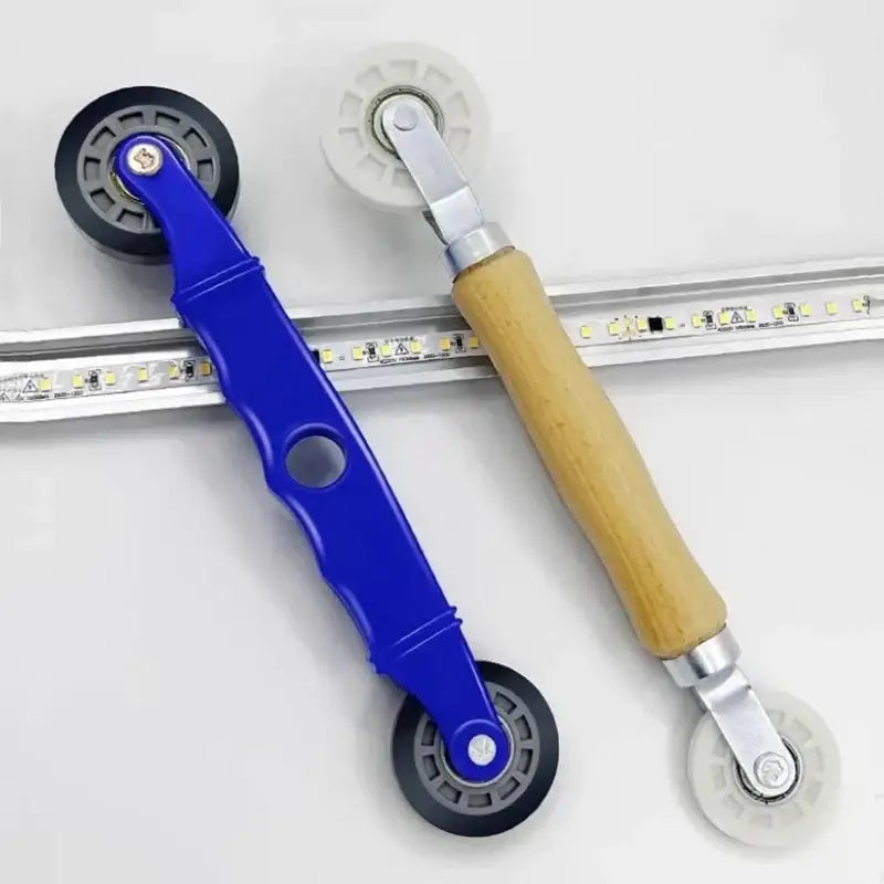 Decorbites™ led strip light installation tool with blue wooden handle and black white rubber wheels for smooth guiding