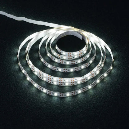 Coiled white decorbites™ led strip light smd2835 with bright bulbs and flexible adhesive backing for versatile use