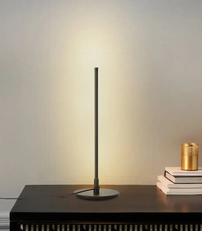Minimalist black metal decorbites led table lamp with sleek cylindrical design and circular base for reading and study