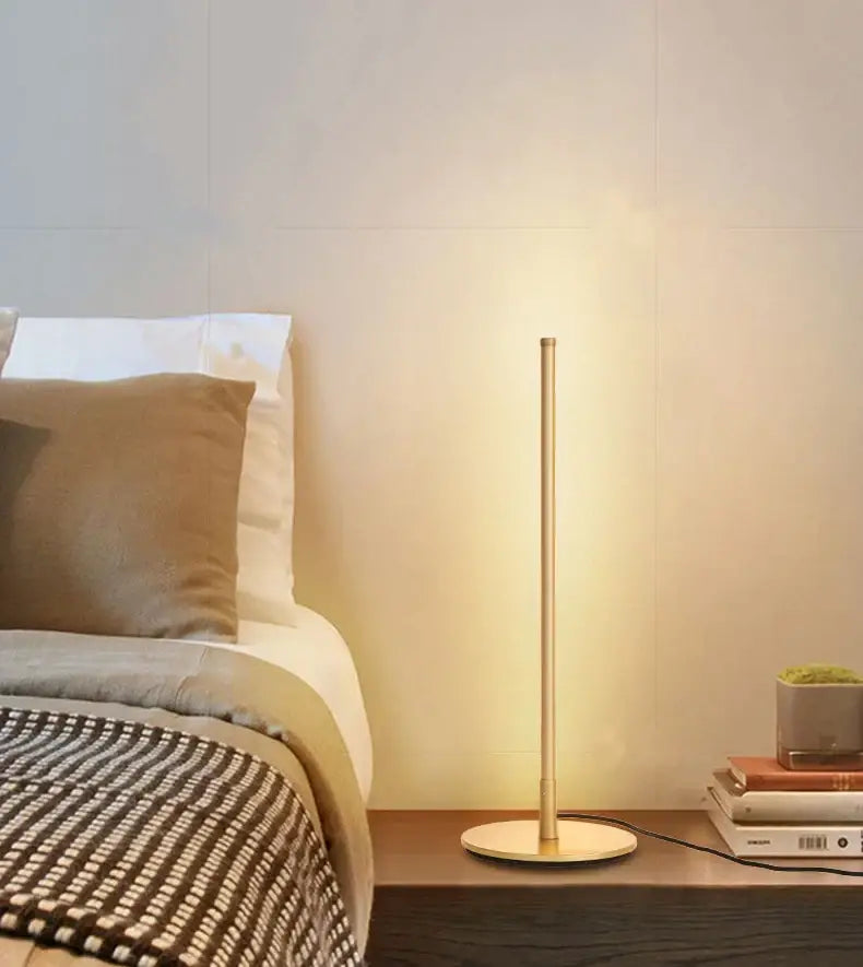 Decorbites led table lamp with slender gold metal stem and circular base ideal for bedroom study and office use