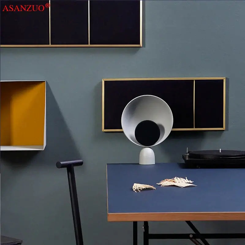 White ceramic table lamp with sleek modern design and black circular center for DecorBites led table lighting