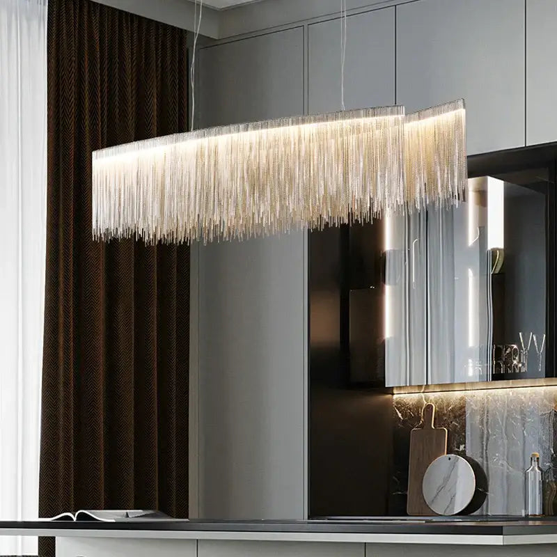 Modern rectangular decorbites led tassel chandelier pendant light with cascading silver metallic fringe emitting warm light