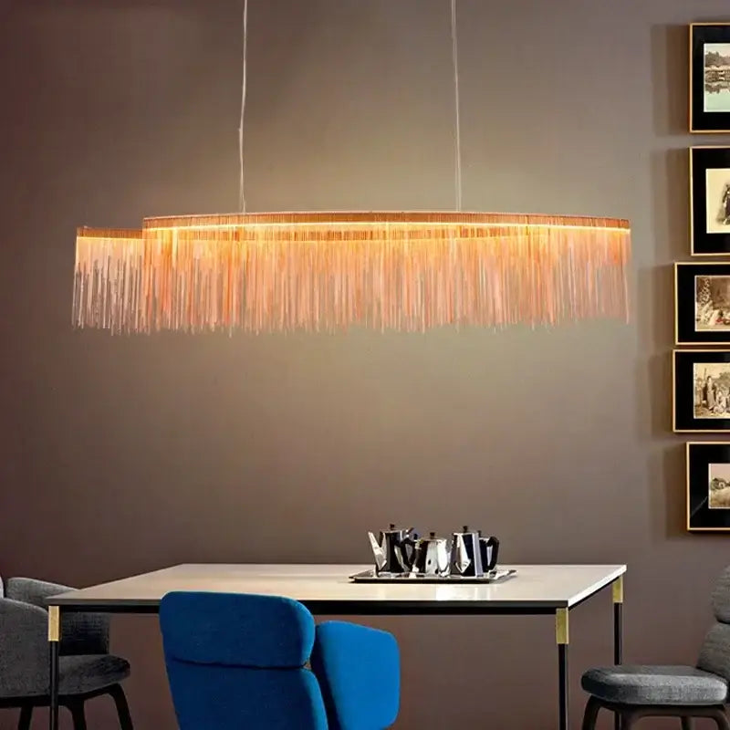 A modern decorbites led tassel chandelier pendant light with warm golden glow and cascading translucent fringed strands