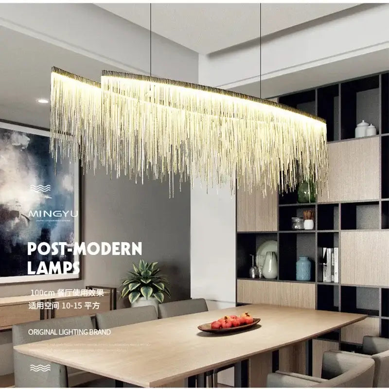 Gold-toned decorbites led tassel chandelier with cascading metallic strands hanging above dining table modern lighting