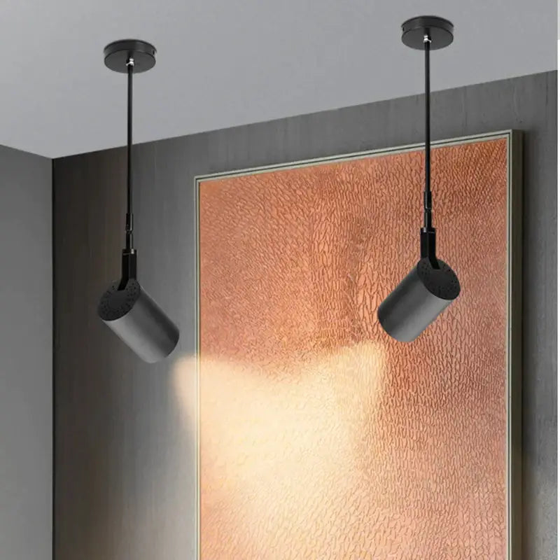 Two sleek matte black aluminium telescopic wall lamps with adjustable heads for galleries by DecorBites™