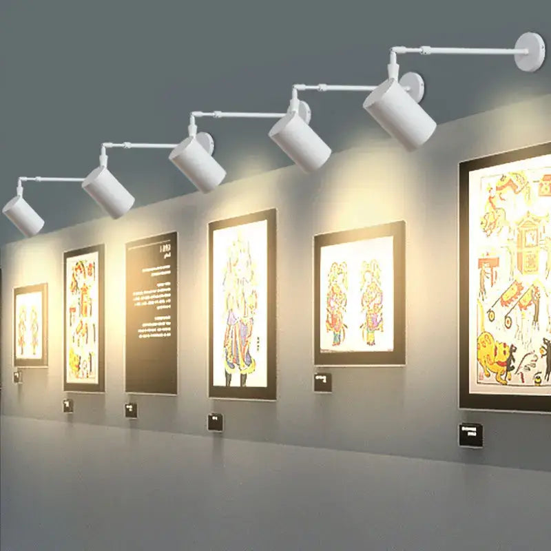 White aluminium decorbites™ telescopic wall lamps with adjustable cylindrical heads for gallery lighting
