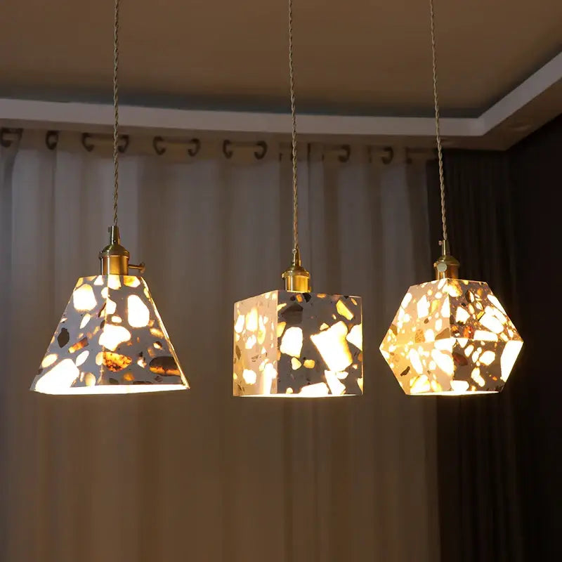 Three decorbites led terrazzo geometric pendant lights with warm terrazzo glass shades and brass chains for indoor use