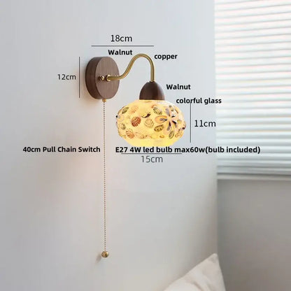 A warm-toned decorbites led tiffany style wall sconce with walnut base and colorful glass floral globe design