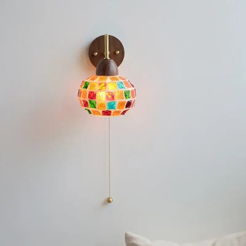 DecorBites led Tiffany style wall sconce with vibrant mosaic glass globe, brass accents, and dark wood backplate