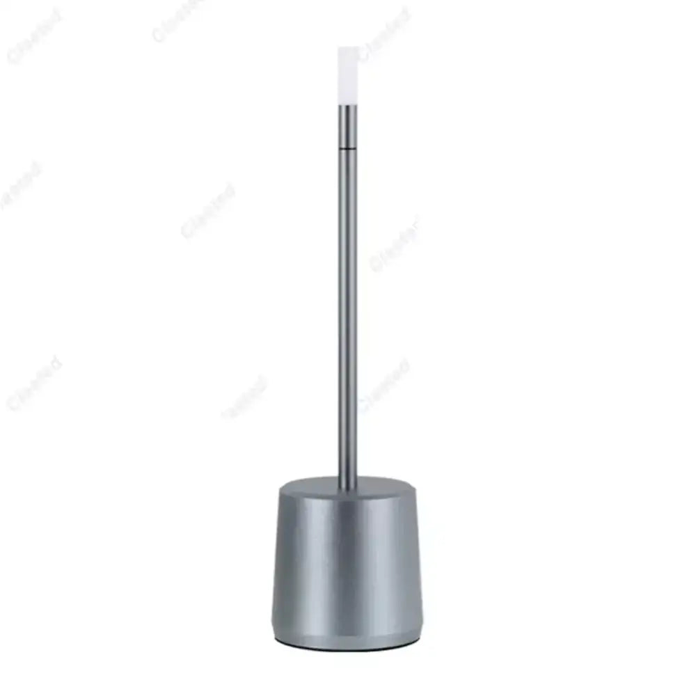 Modern silver-toned metal toilet brush stand with sleek cylindrical base alongside decorbites led touch table lamp