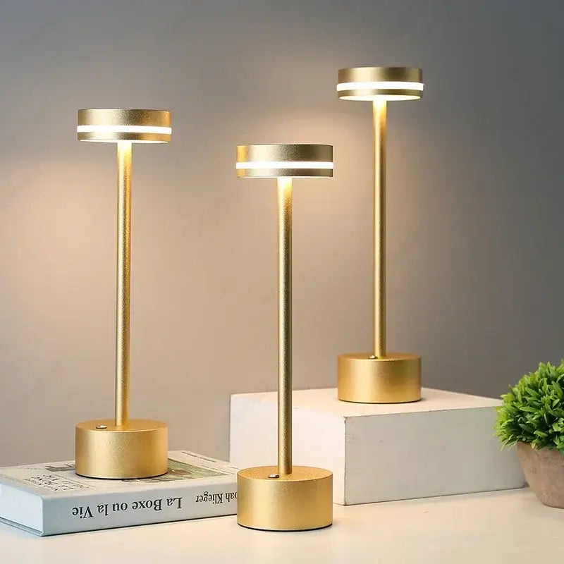 Three sleek gold decorbites led touch table lamps with cylindrical bases and warm rechargeable three-tone lighting