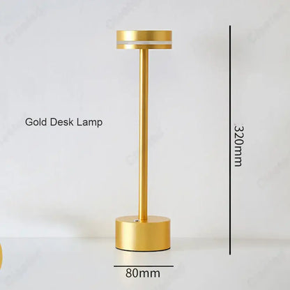A sleek minimalist gold decorbites led touch table lamp with cylindrical base and slender stem for living room lighting