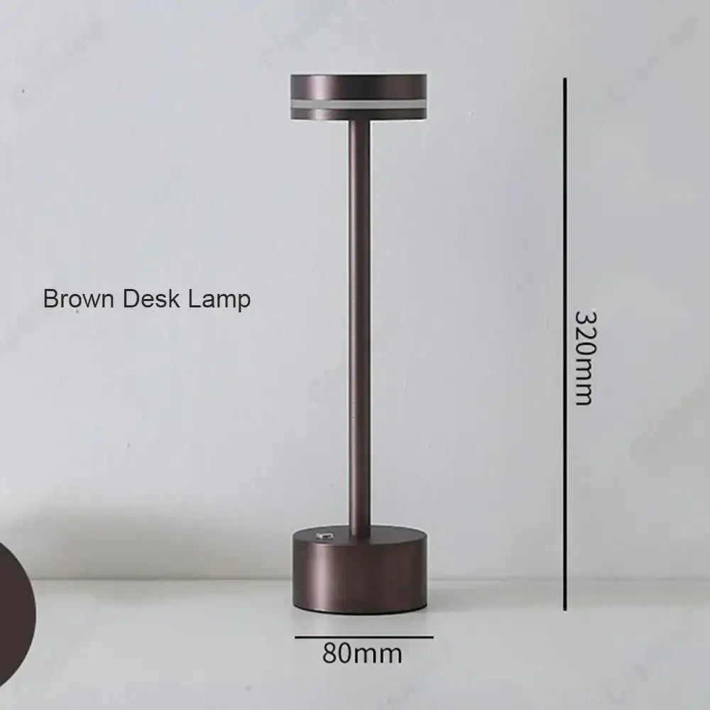 A sleek minimalist brown decorbites led touch table lamp with cylindrical base and three-tone rechargeable lighting